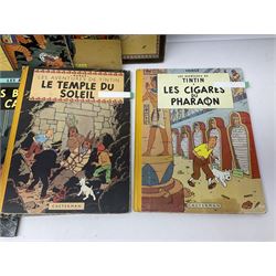 Twenty one first edition Herge, 'The Adventures of Tin Tin' books published by Casterman Bruxelles, with French text and coloured comic strip illustrations throughout; comprising Tintin Au Congo 1946, Tintin En Amerique 1946, Les Cigares du Pharaon 1955, Le Lotus Bleu 1946, L'Oreille Cassee 1943, L'ile Noire 1943, Le Sceptre d O'ttokar 1947, Le Crabe Aux Pinces D'or 1943, L'Etoile Mysterieuse 1942, Le Secret de la Licorne 1943, Le Tresors de Rackan Le Rouge 1945, Les 7 Boules de Cristal 1948, Le Temple du Soleil 1949, Au Pays de L'Or Noir 1950, Objectif Lune 1953, On a Marche sur la Lune 1954, L'Affaire Tournesol 1956, Coke en Stock 1958, Tintin au Tibet 1960, Les Bijous de la Castafiore 1963 and Vol 714 Pour Sydney 1968
