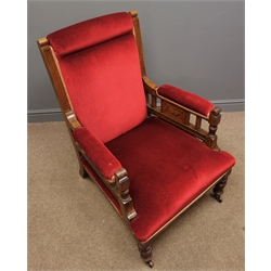  Edwardian oak armchair, moulded uprights, sides carved with swags, upholstered in red velvet, on turned reeded supports, W70cm  