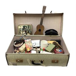 Ukelele, Westclox electric alarm  clock, vintage tins, National Rail hat, ceramics, boxed games, carved wood figures etc all housed in a suitcase
