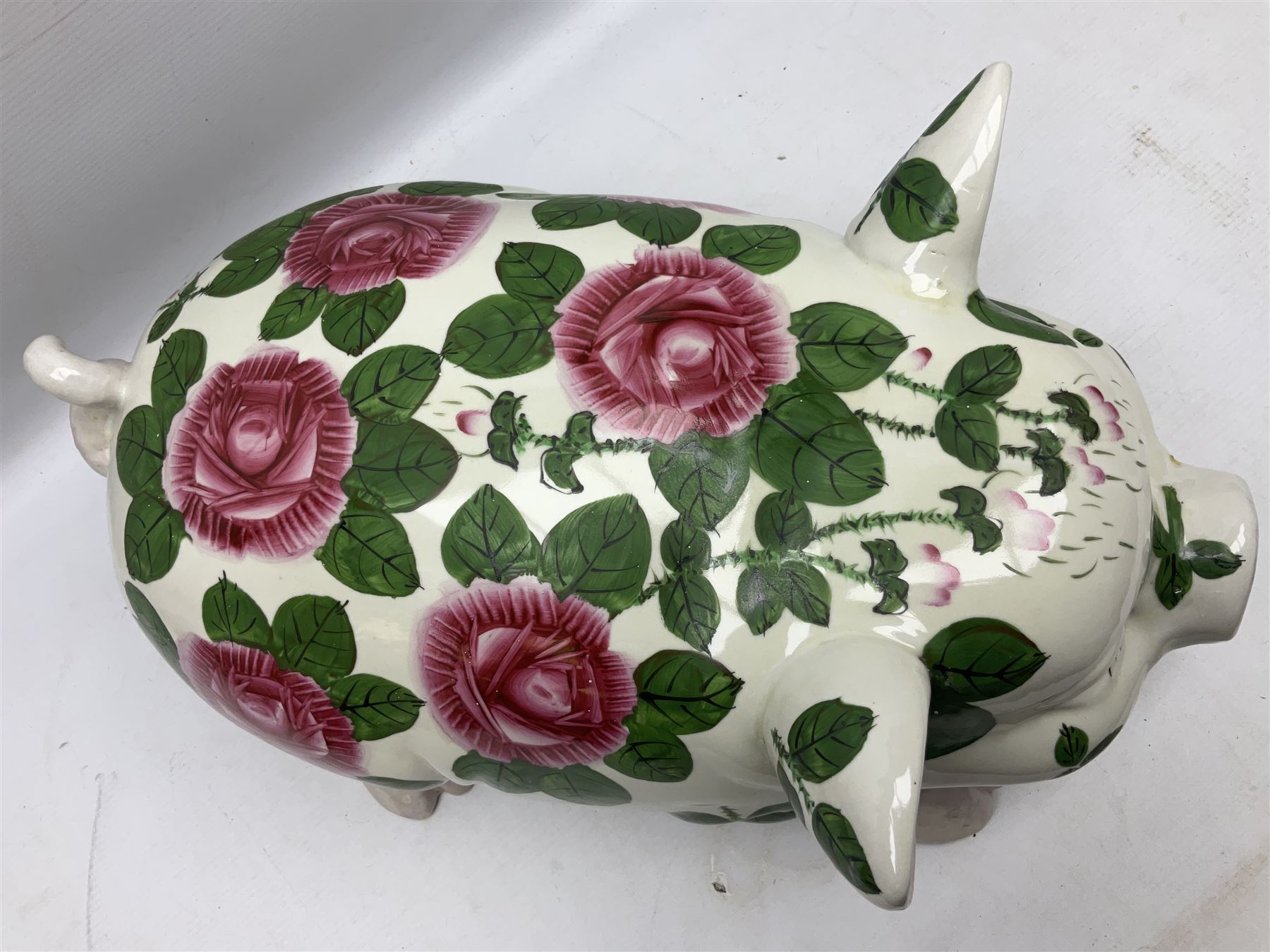 Large ceramic figure of a pig decorated with roses, L45cm