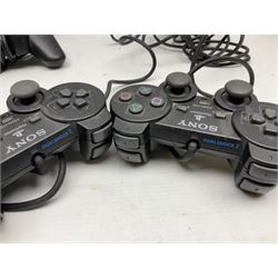 Sony PlayStation 3 60GB console with one PS3 controller, two PS2 controllers, BD remote control, PSP handheld gaming console with case, GAMEware PSP essentials pack, and a selection of PS2, PS3 and PSP games in original cases with instruction booklets 