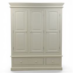 Modern white three door wardrobe, with two hanging section and shelving area, above a long drawer and a short drawer to the base, raised on a moulded plinth
