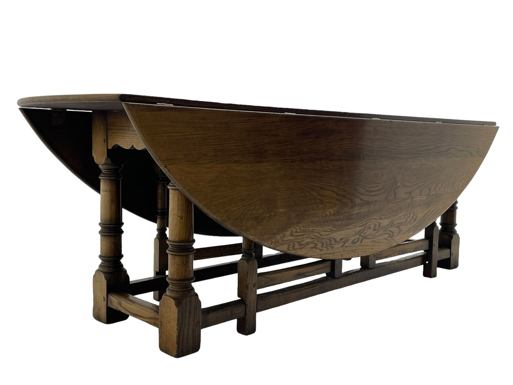 Large 18th century design oak wake or dining table, oval drop-leaf top, turned supports with double gate-leg action base, united by moulded stretchers 