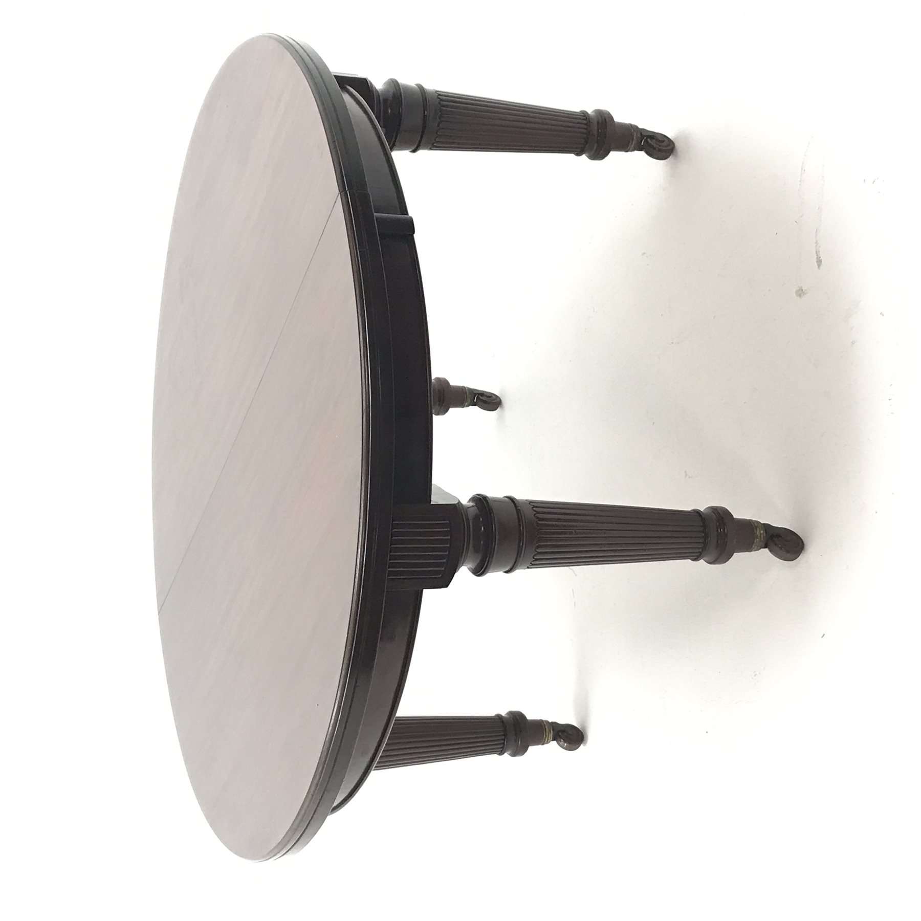 Spillman & Co. London - large Victorian mahogany extending dining table with three additional leaves, on turned and reeded supports with ceramic castors, ivorine label to underneath 'Spillman & Co. St. Martins Lane, London', diameter - 137cm (closed), L302cm (with all leaves)