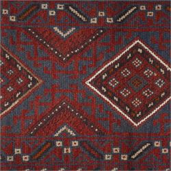 Afghan hand-knotted wool runner, dark red and indigo blue madder, with a repeating diamond medallion design within multiple geometric borders, with flatweave ends 