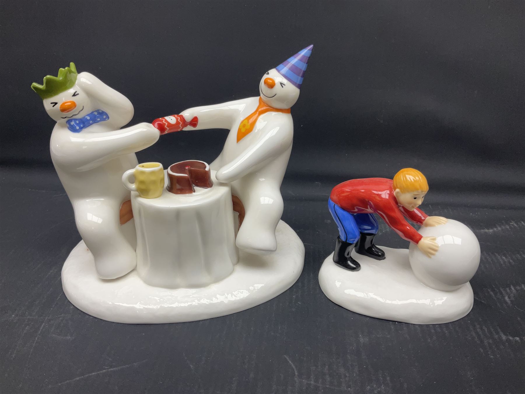 Four Coalport Characters The Snowman figures, comprising I'll Never Forget you with certificate, Pulling a Cracker and Adding a Smile, all with original boxes