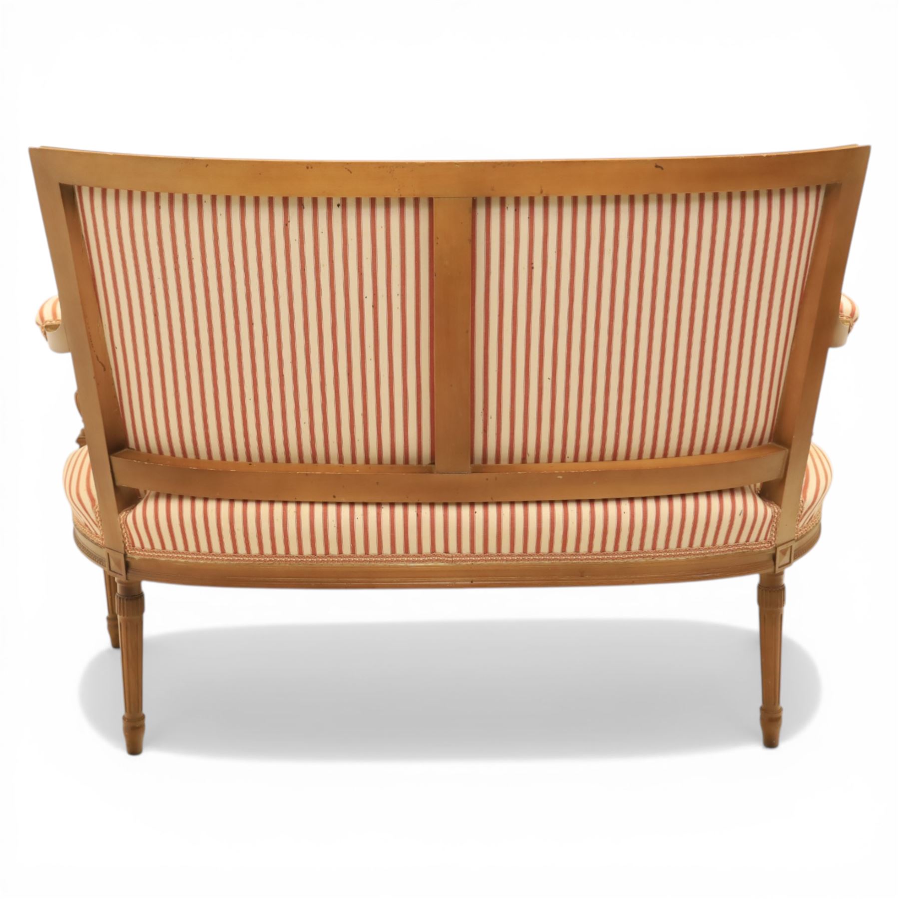 20th century Louis XVI style beech salon suite, comprising settee and four chairs, the settee with shaped rectangular back and upholstered arms over a shaped seat, the chairs with rectangular backs and overstuffed seats, each upholstered in striped fabric with close-nailed borders, upon fluted tapering supports headed by carved paterae, terminating in toupie feet, chairs H89cm W47cm