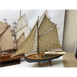 Eight model ships or boats including fishing boat with fish, nets and buoyancy aid, two mast sailing ship complete with cannons, two mast yacht with detailed rigging and life boat etc, the largest L72cm, H60cm