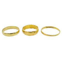 Two 22ct gold wedding bands and an18ct gold wedding band, all hallmarked