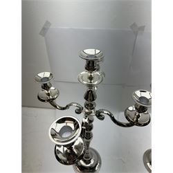 Pair of four branch candelabras, urn-shaped nozzles raised upon scroll branches supported from tapering central stem, with a stepped circular base, H59cm