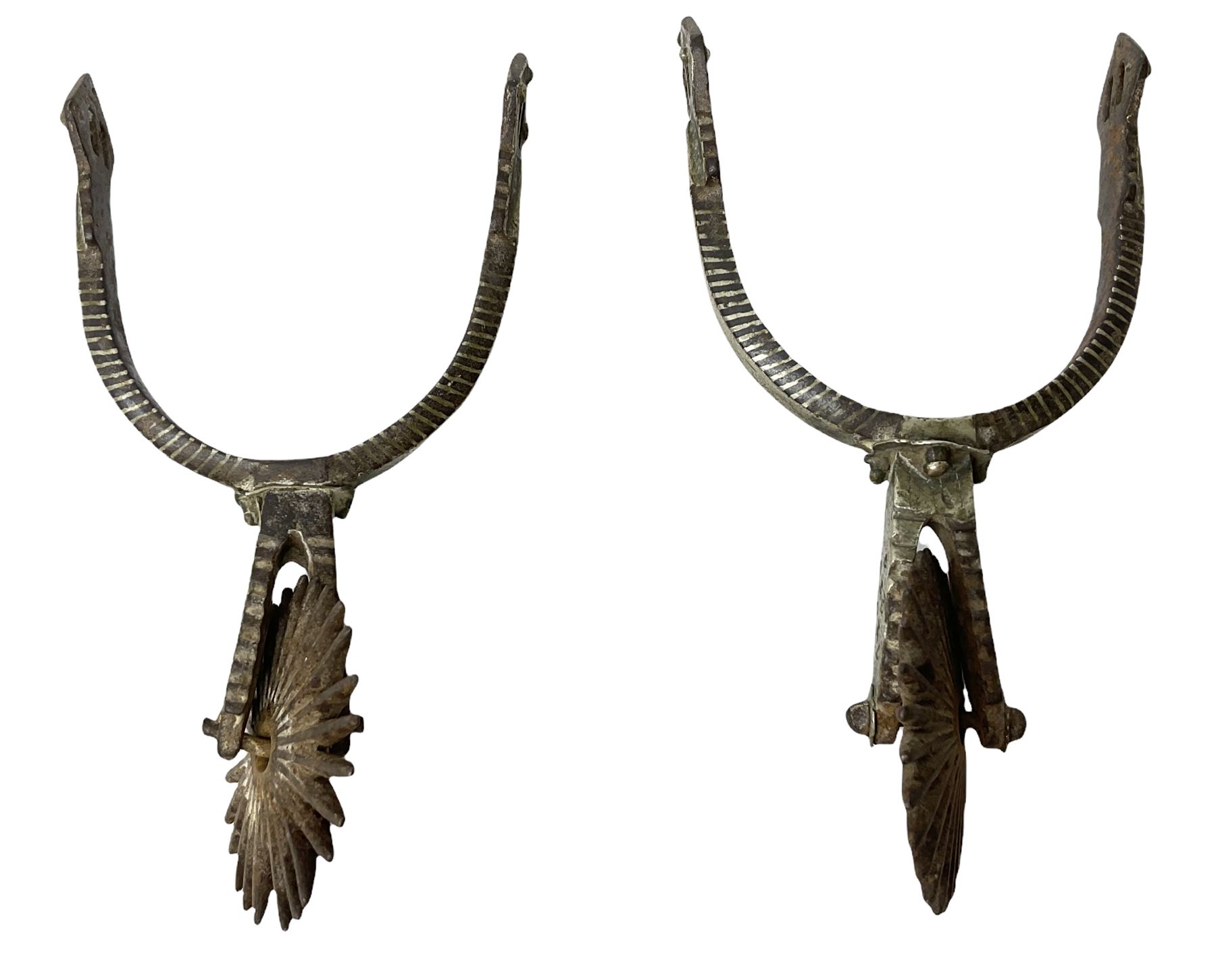Pair of late 19th century South American iron spurs, engraved silver mounts, with sunburst rowls