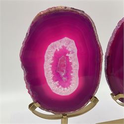 Pair of pink agate slices, polished with rough edges raised upon gilt metal stands, H20cm