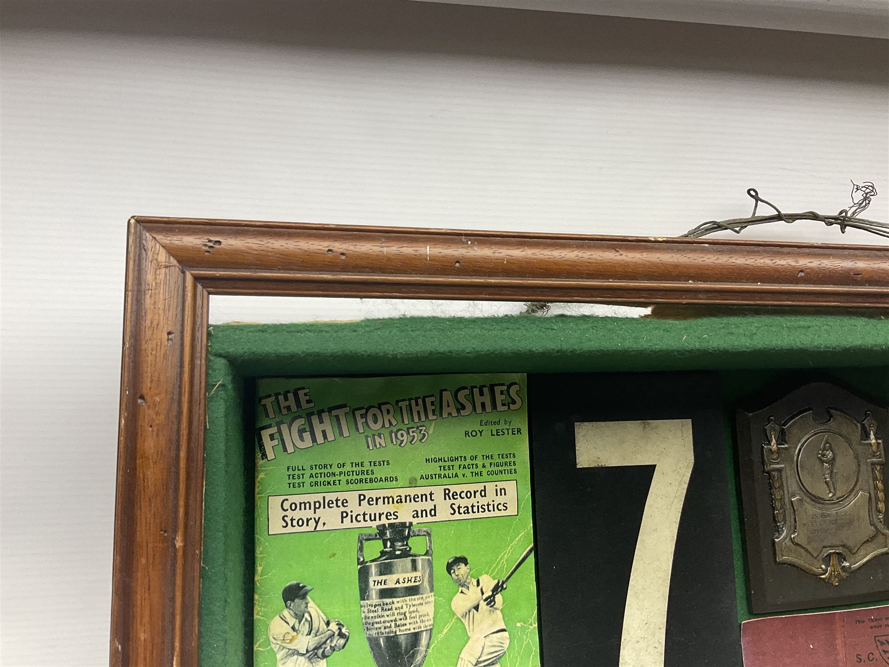 Four framed sporting memorabilia displays, the largest example containing 1930s cricket memorabilia, together with two fishing displays and a football display, each within wooden glazed frames, largest H105cm