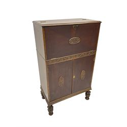 Early 20th century oak cocktail cabinet, fall front with fitted retractable interior, double cupboard below, on acanthus carved baluster feet