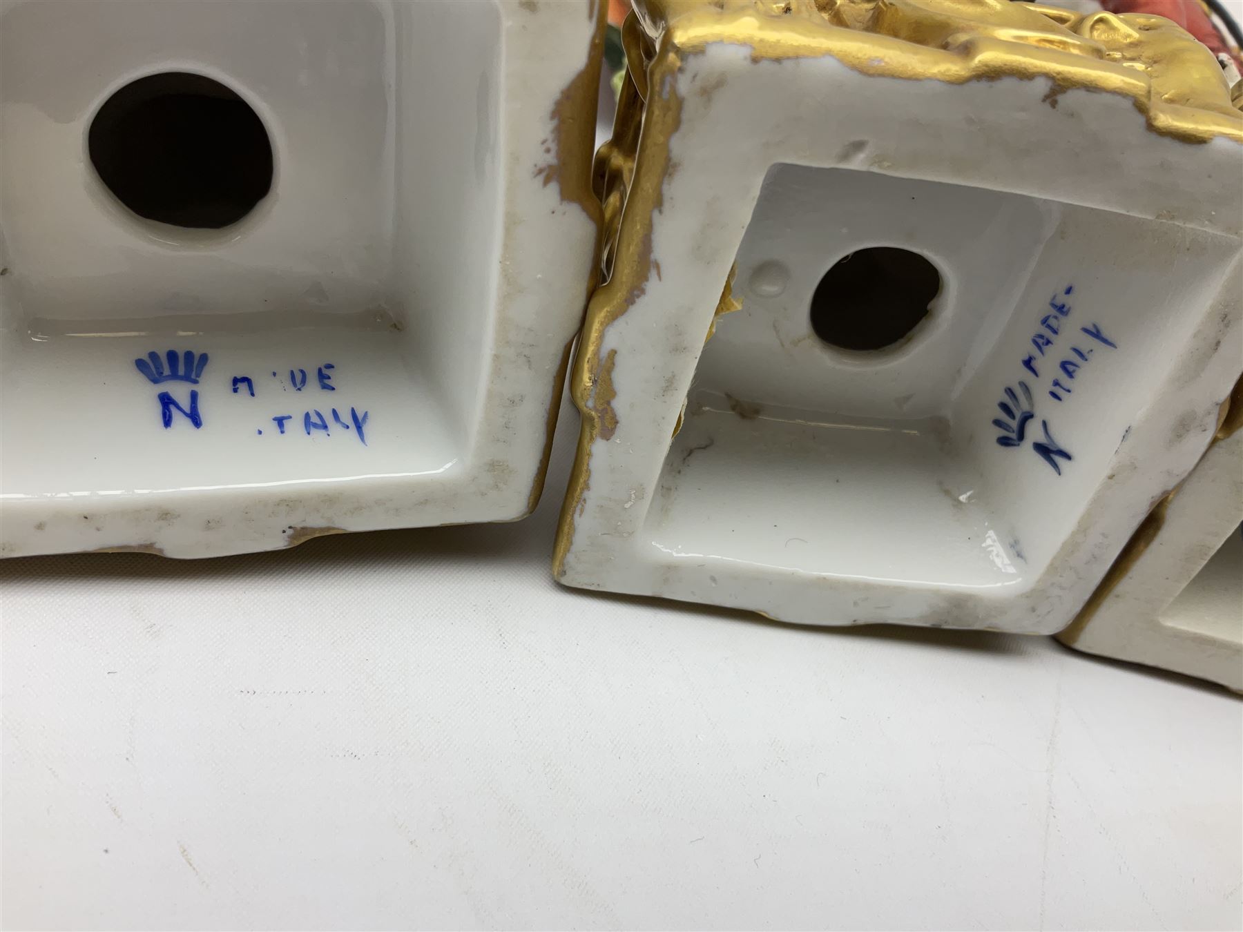 Group of seven Capodimonte figures of soldiers, to include four Bruno-Merli examples including Officer of the 12th Lancers 1820 and Captain of the 18th Hussars 1815, both raised upon ornate gilt plinths bearing British monarch motto in Latin 'Dieu et mon droit', and three further similar, all with crowned N mark beneath, tallest H32cm