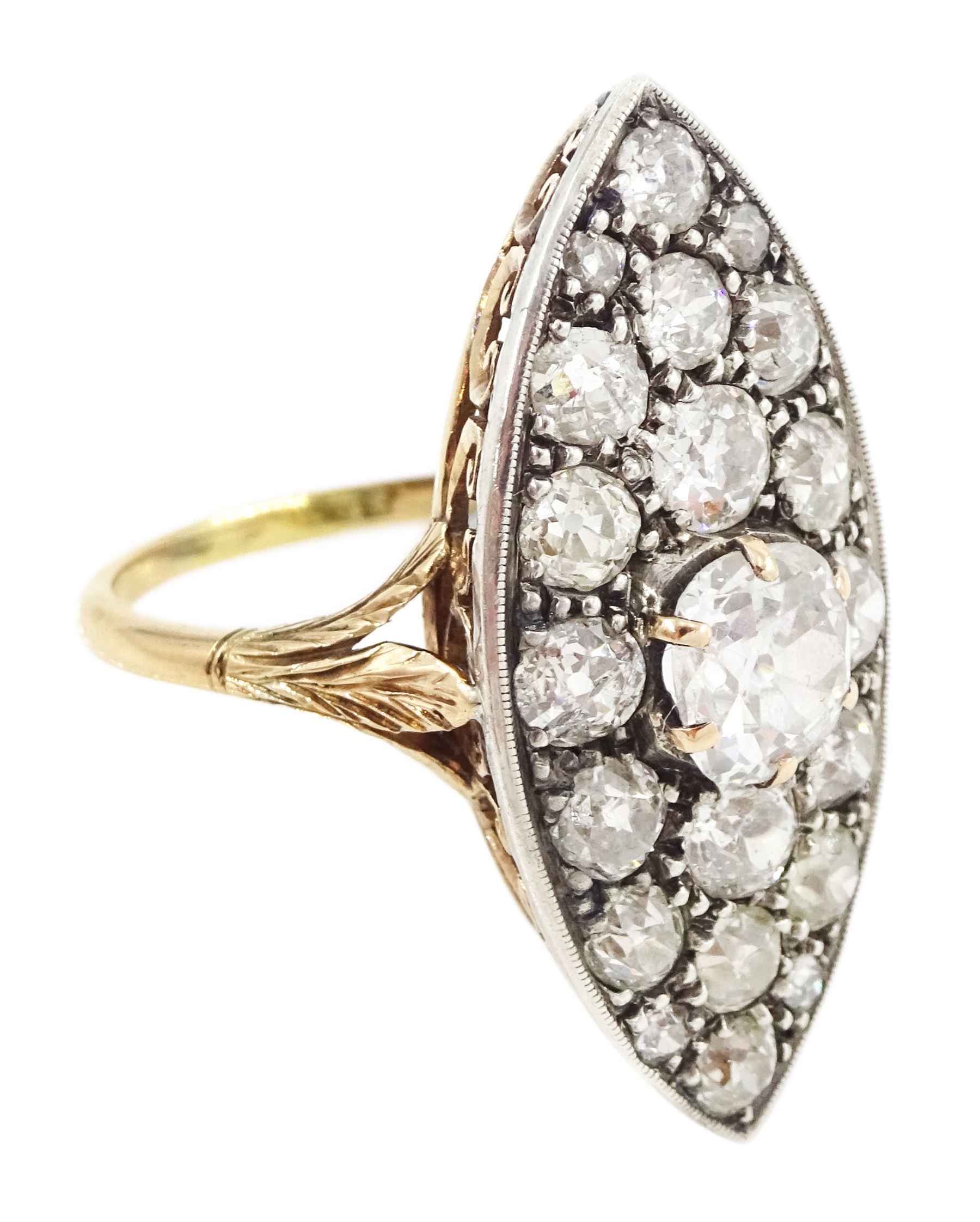 19th century 18ct gold and silver diamond marquise shaped cluster ring, the principal old cut cushion cut diamond of 1.15 carat, in a six claw setting, with pave set old cut diamond surround of 3.28 carat, pierced scroll design gallery and fleur-de-lis shoulders, French (Paris) import mark, total diamond weight 4.43 carat, with IGI report
