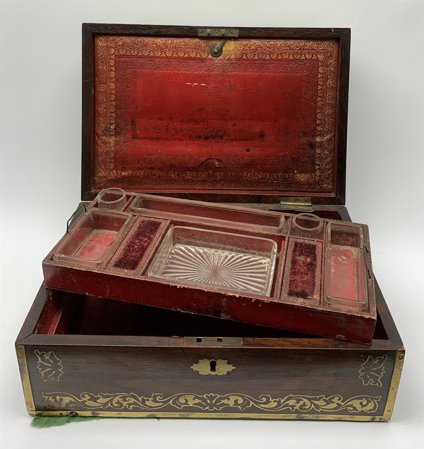 Victorian rosewood vanity box, with scrolling foliate brass inlay and twin brass inset campaign style handles, the hinged cover opening to reveal a gilt tooled interior with divisions, L33cm D22.5cm H13cm