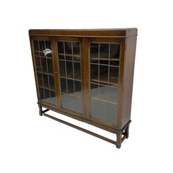 Early 20th century oak bookcase, fitted with three lead glazed doors