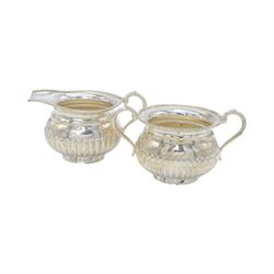 Late 20th century Indian Colonial silver six piece tea and coffee service, comprising coffee pot, hot water pot, teapot, milk jug, open sucrier and tray, all of oval part fluted form, the tea and coffee pot with ebonised wooden handles and finials, stamped SIL and with maker's mark for Cooke & Kelvey New Dehli, within two boxes and with original receipt for 1999