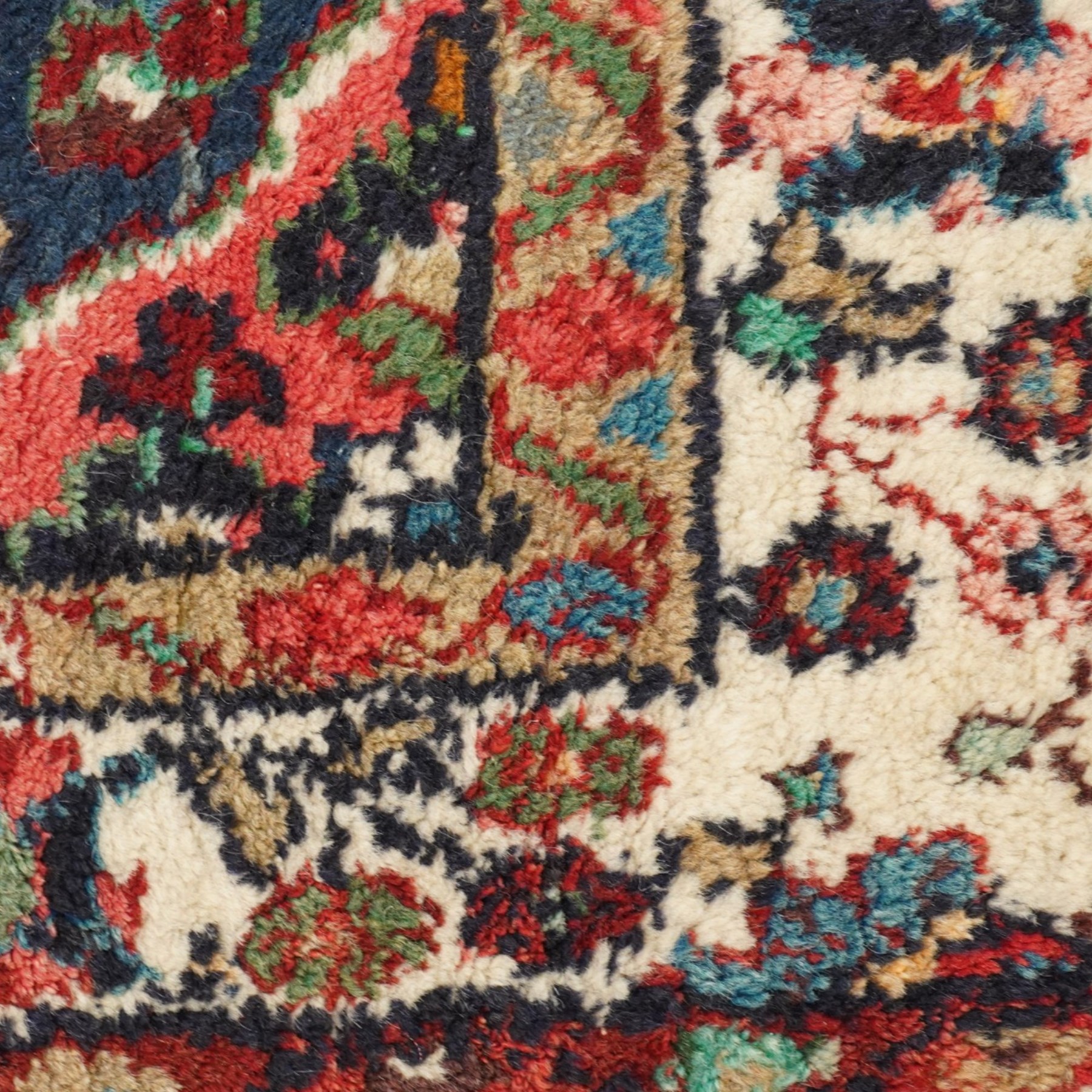 Small Persian crimson ground Hamadan rug, decorated with central medallion surrounded by stylised foliate motifs with repeating guard lines