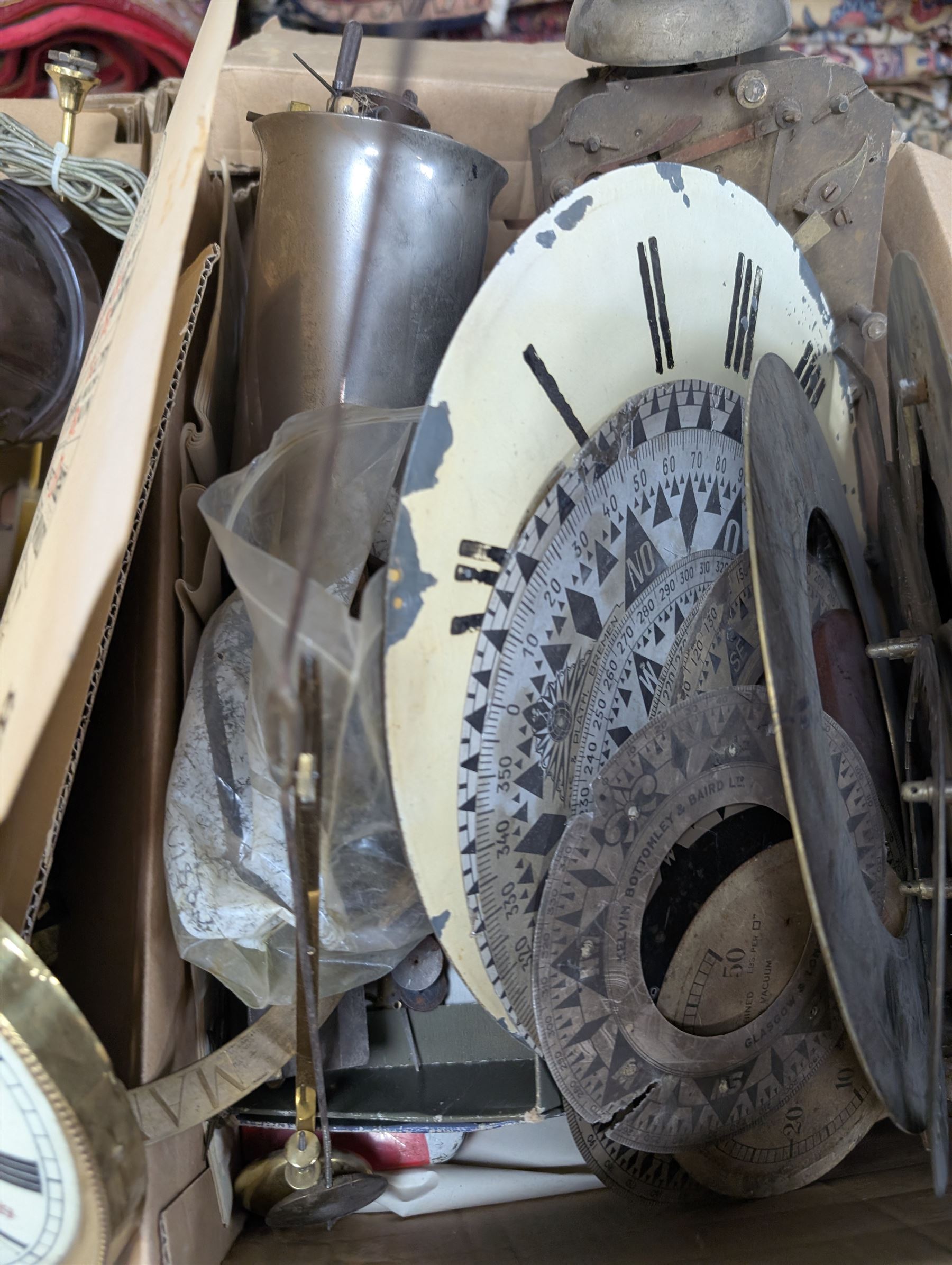Collection of clock parts and accessories, including movement, faces, dials, tools, brass fittings, etc, in three boxes