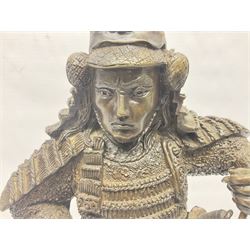 Bronze figure of a samurai standing wearing armour and holding a naginata, upon a rocky base, H48cm