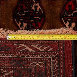 Afghan Bokhara dark amber and terracotta ground rug, decorated with Hac and Gul motifs  within multiple geometric guard bands