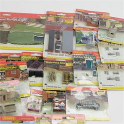 Forty-six Hornby N Gauge Lyddle End model railway trackside buildings and accessories, including N8574 Canal Bridge Adapter and Ramps, N8724 Castle Ruins Walling x 3, N8069 Tractors, N8018 Cotswold Stone Wall and N8096 Low Relief Terrace, all carded