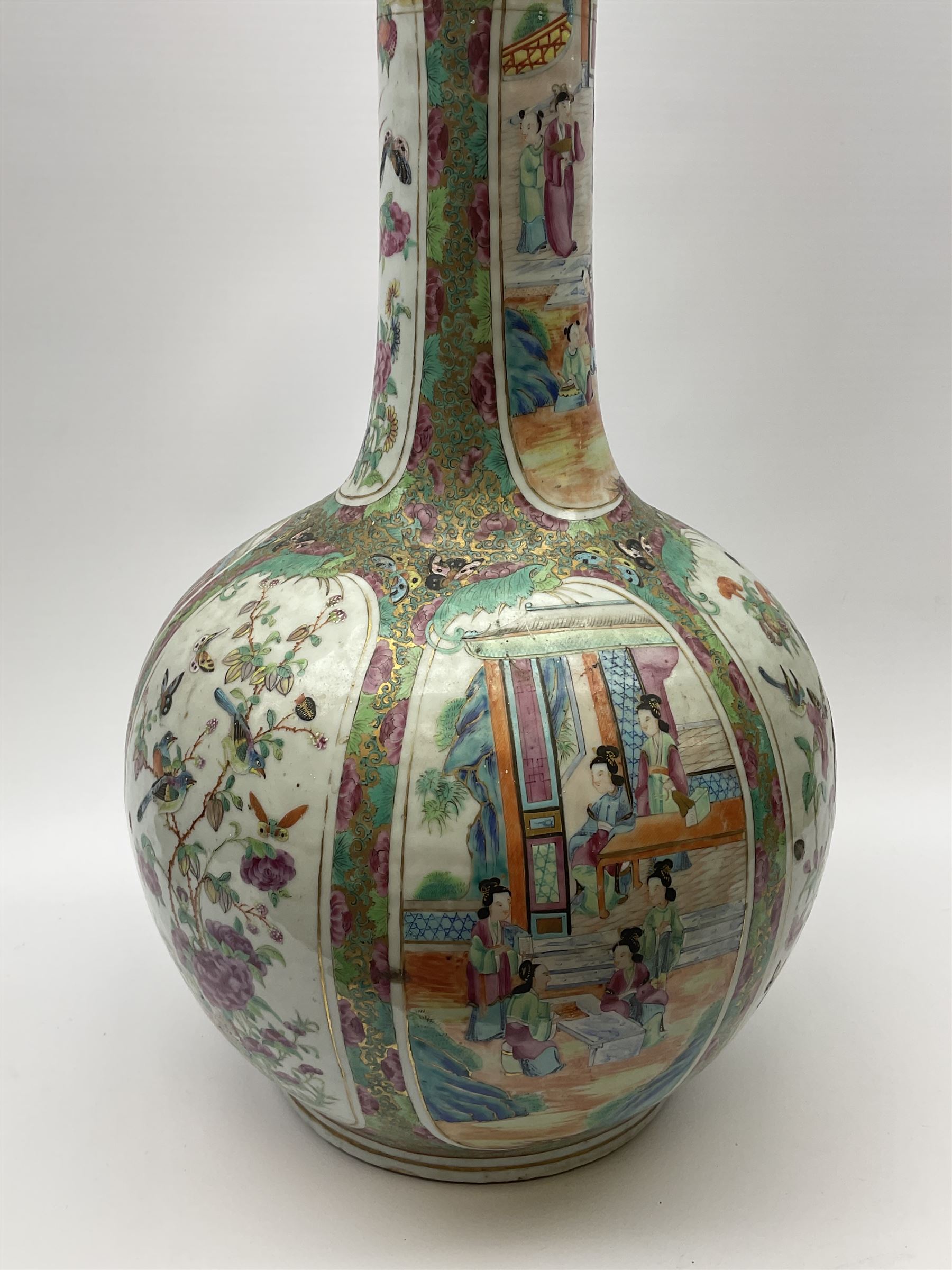 A 19th century Chinese Canton Famille Rose vase, of globular form with tall neck, and cover with finial, decorated with alternating panels of figural scenes, and birds and butterflies amongst blossoming and fruiting trees, with foliate surround against gilt, overall H57cm. 