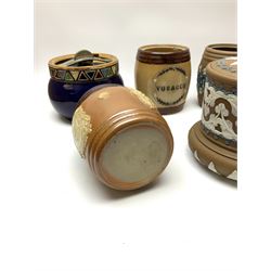 A group of Doulton Lambeth and Royal Doulton tobacco jars, most with relief moulded foliate decoration, (four examples lacking covers), largest example H15cm. 