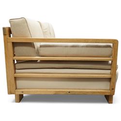 Mid 20th century German Art Deco oak framed divan day bed, rectangular form with slatted side supports, upholstered in cream linen with three removable back cushions, three seat cushions and cylindrical bolster arms, on block feet