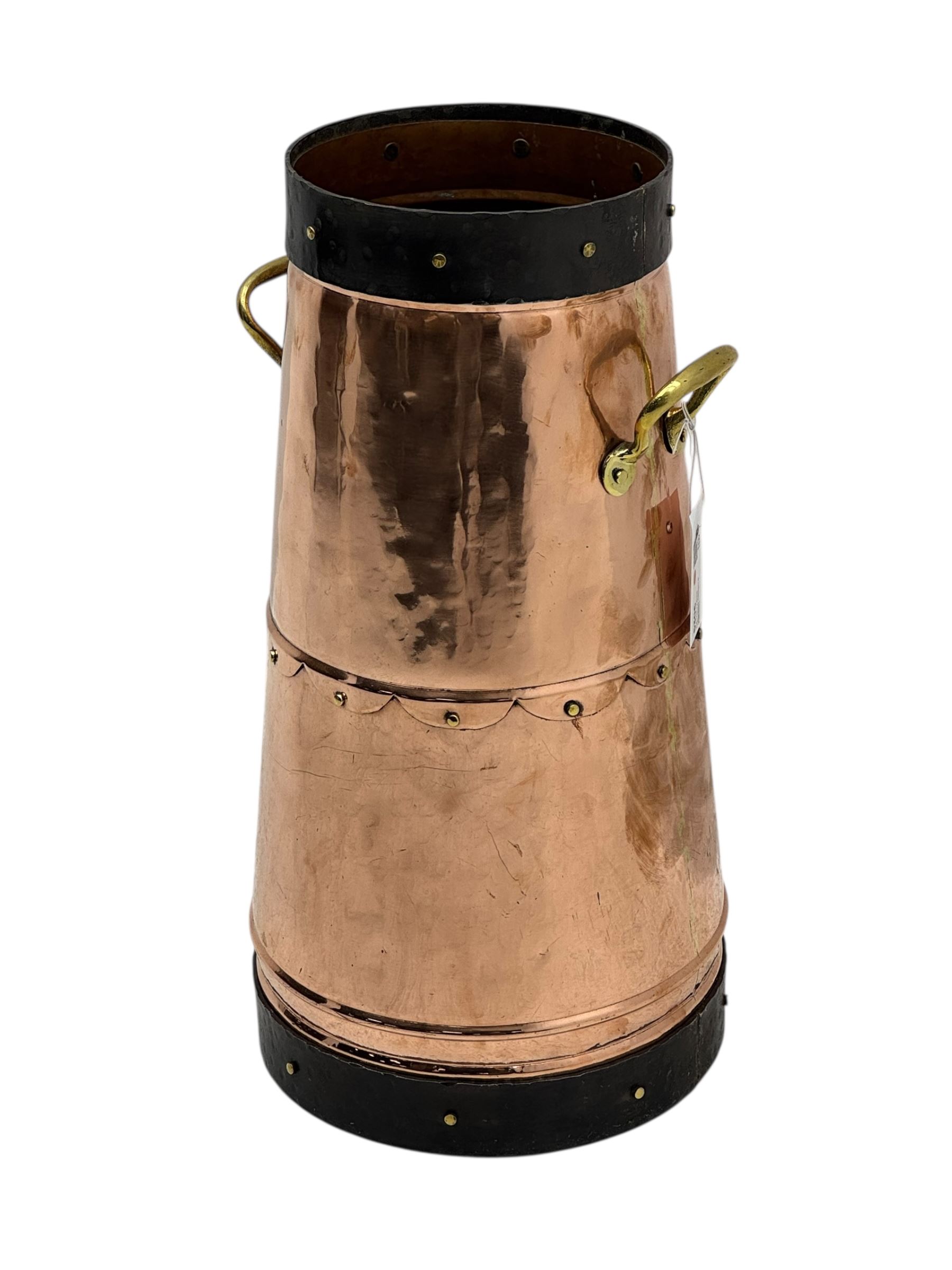 20th century copper milk churn, of tapering cylindrical form with applied brass twin handles and darkened banded rim and base