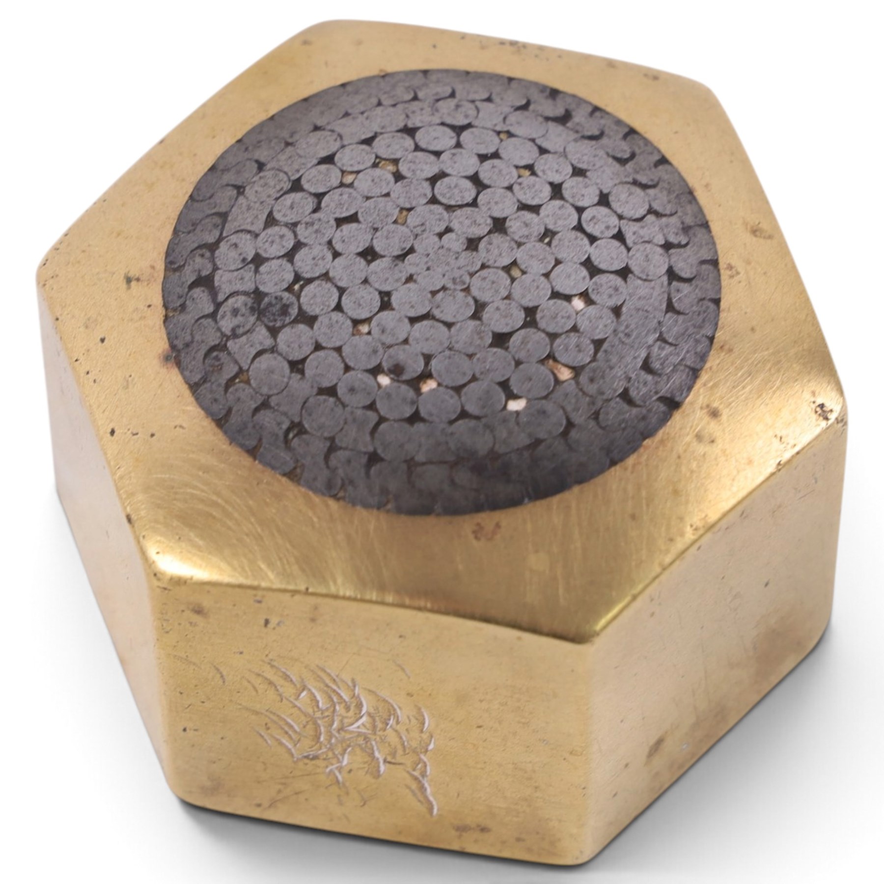 Two 1930s mining interest brass paperweights, comprising a hexagonal brass and steel example containing winding gear cables from the Wheldale Colliery and a smaller brass example with glass dome, advertising copper winding gear cables inscribed Anchor Cable Co, tallest H3cm