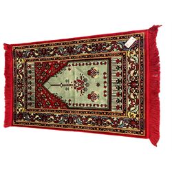 Turkish crimson and light blue ground prayer rug, the field decorated with stylised plant motifs, scrolling foliage pattern border 