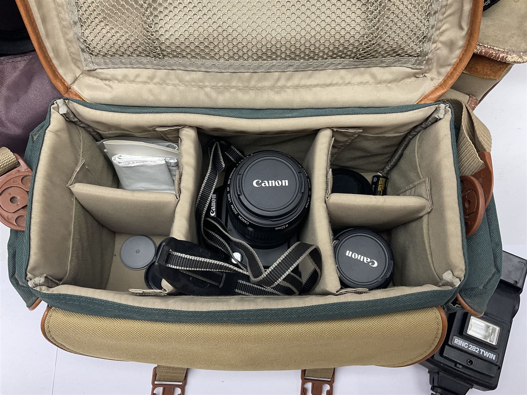 Cameras and accessories, to include Olympus OM101 Power Focus camera body, serial no 1076067, with 'Sigma AF Zoom 1:38, f=75 200mm' lens, serial no 2053714, Canon EOS 5000 camera body, serial no 1507812, with 'Canon Zoom EF 80-200mm, 1:4.5-5.6' lens, other cameras, by Miranda, Coronet and Ricoh and a collection of lenses, carry cases, etc 