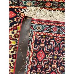 North West Persian Senneh indigo and crimson ground runner, the Herati decorated field with five interconnected lozenges, triple band border with repeating flower head motifs 