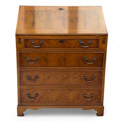 Mid-20th-century Georgian design cherrywood and burr walnut  veneered bureau, fall front with inset tooled leather writing surface revealing a fitted interior with small drawers and pigeon holes, and a central cupboard with oval inlay, over four long graduated drawers, raised on shaped bracket feet 