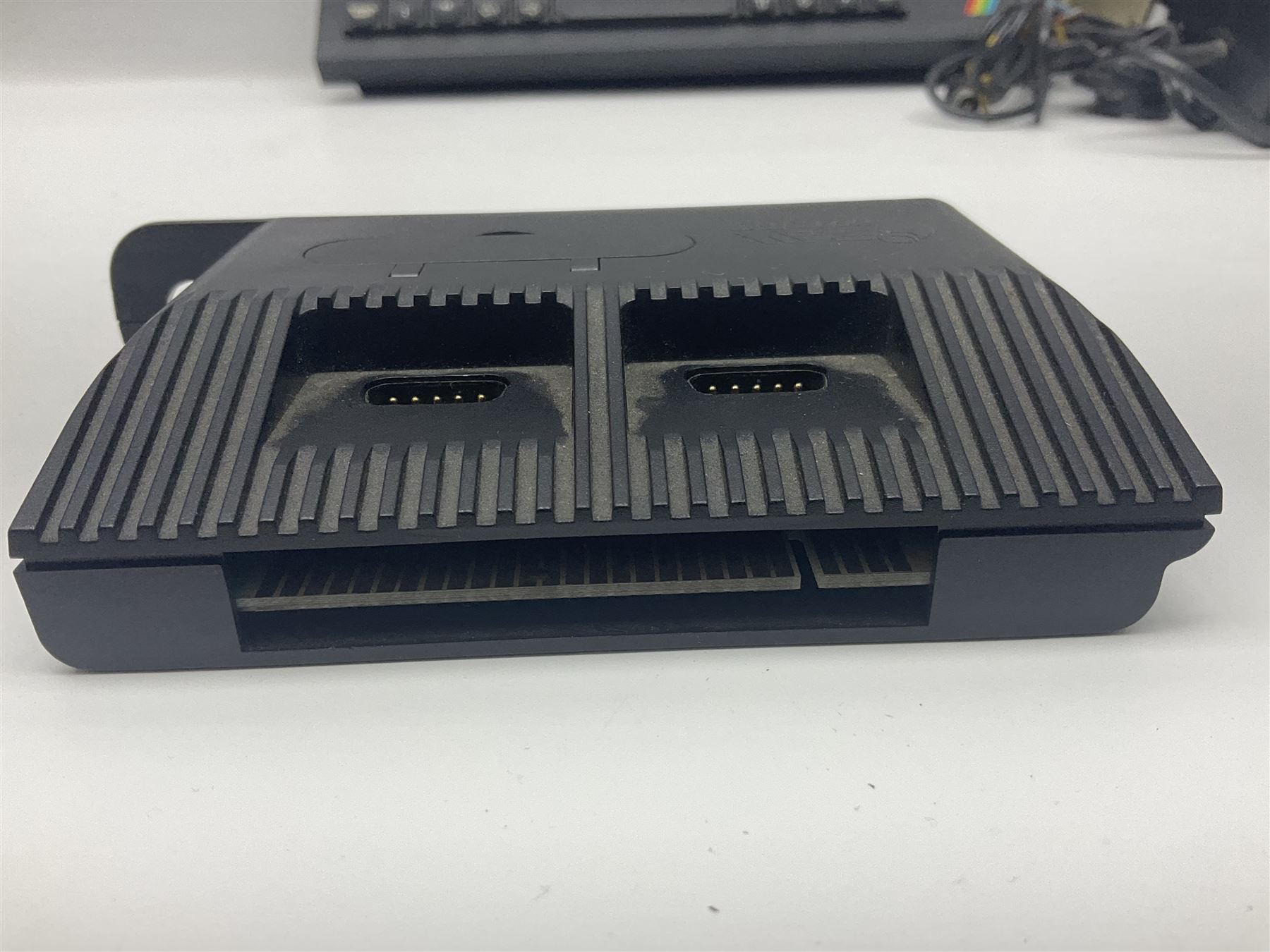 Sinclair ZX Spectrum (1984) with accessories and games; ten games for Sinclair Spectrum and 48K Spectrum to include ‘Knight Lore’, ‘The Way of the Exploding Fist’, and ‘Green Beret’ all in original boxes, ‘Rambo First Blood Part II’ without original box; Sinclair UK1400 Power Supply Unit, Hales Universal Mains Adapter, RAM Turbo Spectrum Joystick Interface, Starlite Cassette Player, all without boxes