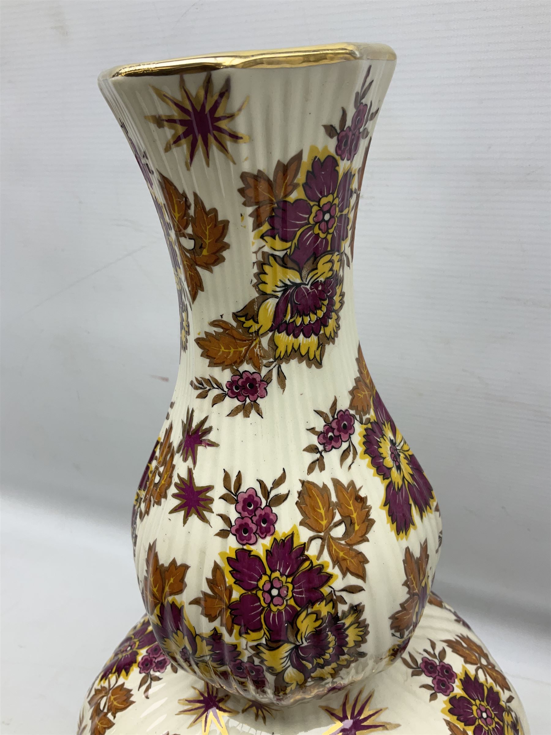 Mid 20th century Boch Freres of Belgium Keralux Fleur De Saxe vase, of double gourd form with pink and yellow flowers amongst orange foliage and gilt decoration, H44cm