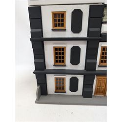 1:24 scale four-storey tudor-style dolls house, with black and white exterior, balcony garden, glazed panelled windows and wooden shingle roof, with decorated interior and wired fireplaces and lighting, H65cm, W58cm, D31cm, 