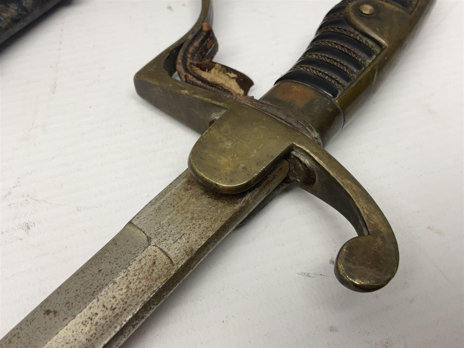 Prussian artillery officer's sword, with 80cm slightly curving fullered  blade, brass hilt with D-shaped langets, curving knucklebow, wire-bound black grip and leather finger loop; in black painted steel scabbard with single suspension loop