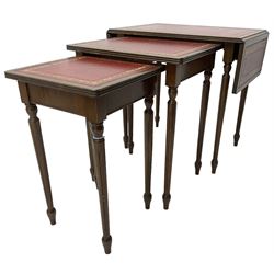 Mid-20th century nest of three mahogany occasional tables, the largest with drop-leaf top, reed moulded tops with inset leather surfaces, on turned and fluted supports