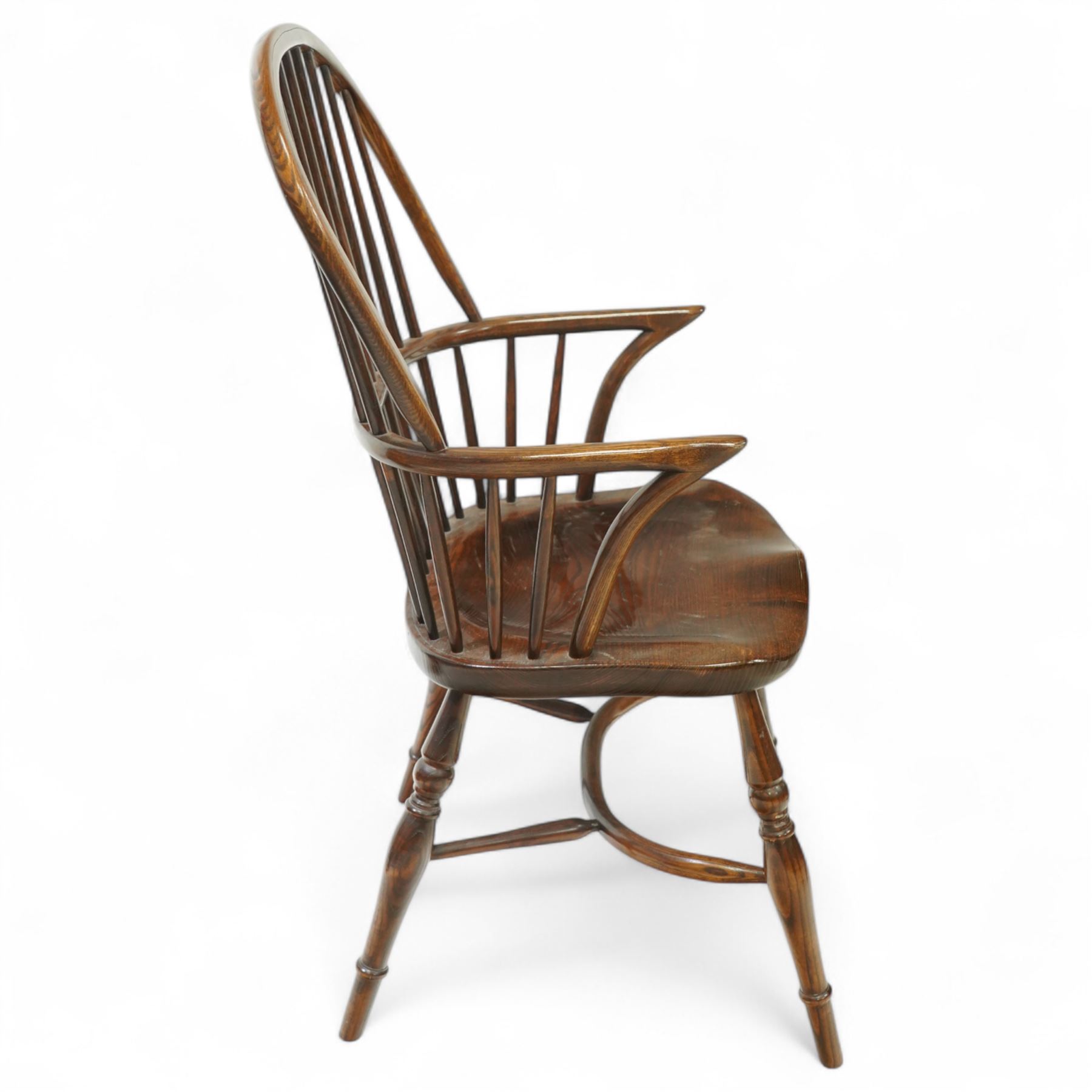 Late 19th century ash and elm Windsor armchair, with hooped back and spindle supports, shaped elm saddle seat, on turned legs united by crinoline stretcher