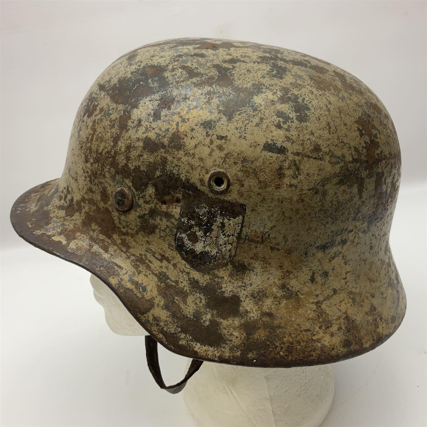 WW2 German Infantry M40 steel helmet with tropical finish and traces of single decal; with chin strap and leather liner marked 57 twice in red; back apron stamped 11 38