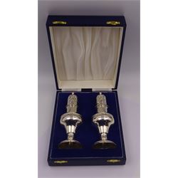 Modern silver two piece cruet set, comprising salt shaker and pepper shaker, both of waisted form with engraved rope twist borders, the removable pierced covers each with engraved lattice decoration, upon a circular spreading foot, hallmarked Laurence R Watson & Co, Birmingham 1989, H14.5cm, contained within velvet lined fitted case