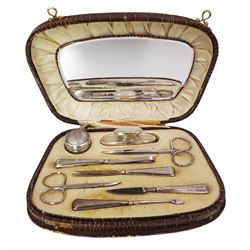 1920's silver handled manicure set including nail files, nail buffer and glass jar, hallmarked Crisford & Norris Ltd, Birmingham 1928, with later stainless steel scissors, in a crocodile skin effect case with velvet and silk mirrored interior 