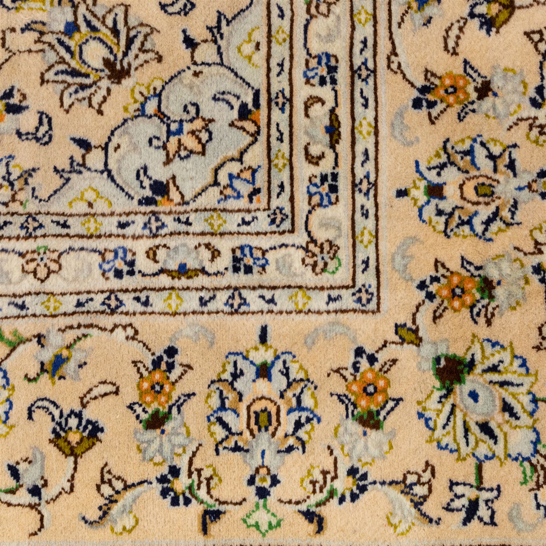 Central Persian Kashan hand-knotted carpet, ivory ground with central rosette medallion surrounded by scrolling floral vines and palmettes, field framed by a meander border flanked by multiple guard stripes, with cotton fringe end and a replaced fringe end