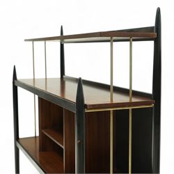 E Gomme for G Plan - 'Librenza' mid-20th century teak and ebonized wood bookcase, rectangular three-tier open shelf design with finials, narrow and raised top shelf above full span and depth central shelf, above divided shelf with open pigeonholes, sides with brass rods, raised on tapering legs with brass capped feet