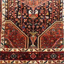 North West Persian Koliahee hand-knotted runner, indigo field with three large linked lozenge medallions in a madder red, framed by angular floral motifs and stylized vines within ivory and terracotta geometric borders, fringe ends  