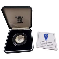 The Royal Mint United Kingdom silver proof coins, comprising 1990 five pence two-coin set, 1998 'His Royal Highness The Prince of Wales Fiftieth Birthday' crown, and 1998 'NHS 1948 -1998' fifty pence coin, all cased with certificates